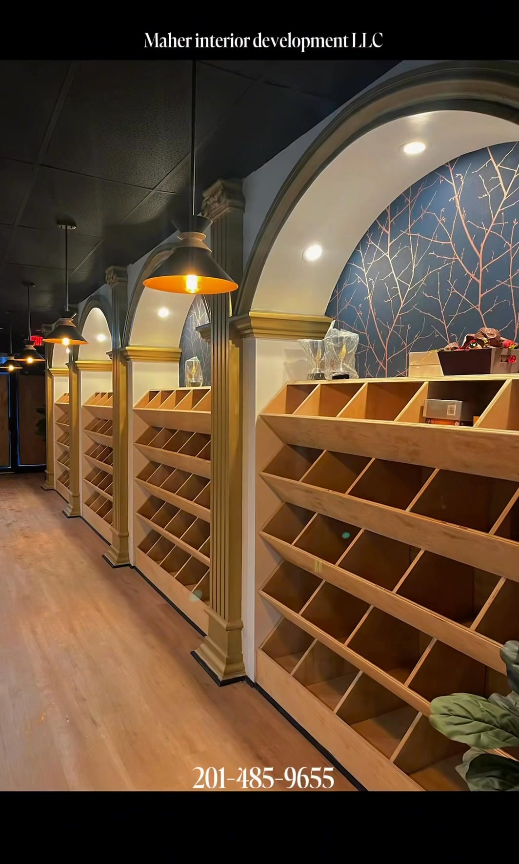 Commercial retail interior with plaster archways, fluted columns and custom wood display shelving